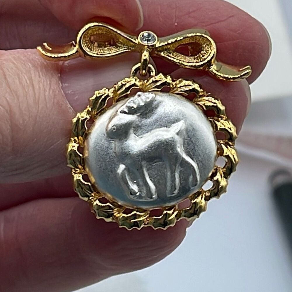 Vintage Monet Reindeer dangle brooch in gold and silver tone.